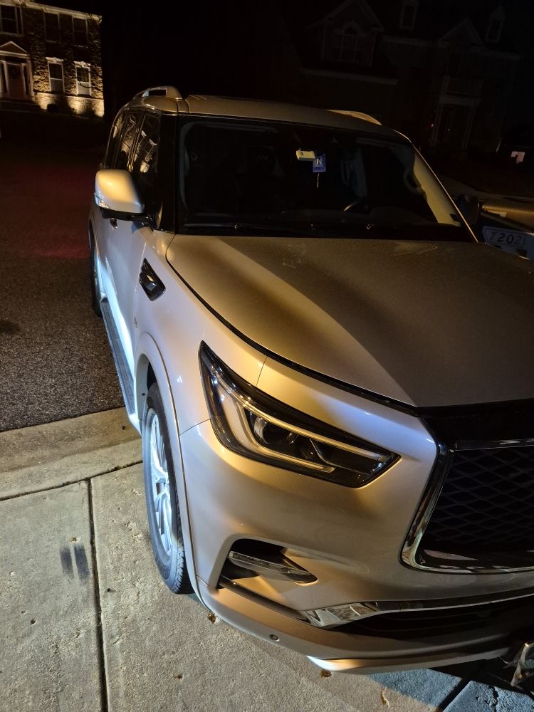 Luxury SUV at night on a Maryland street waiting for roadside assistance