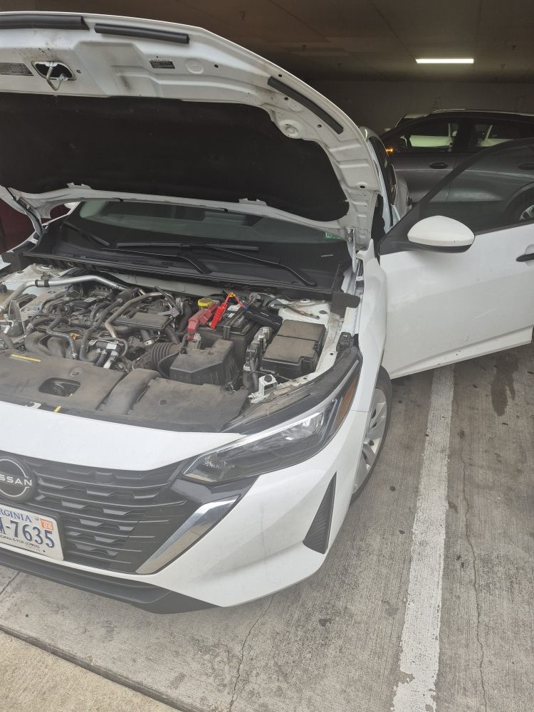 Engine bay jump start performed in a parking garage
